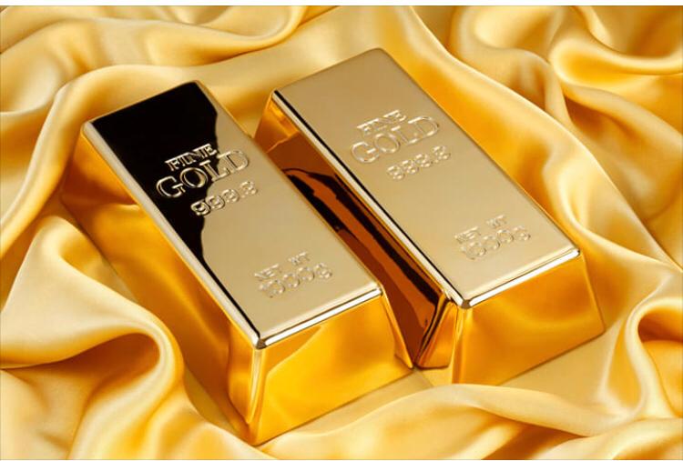 Two Fine Gold 999.9 bullion bars resting on gold satin fabric