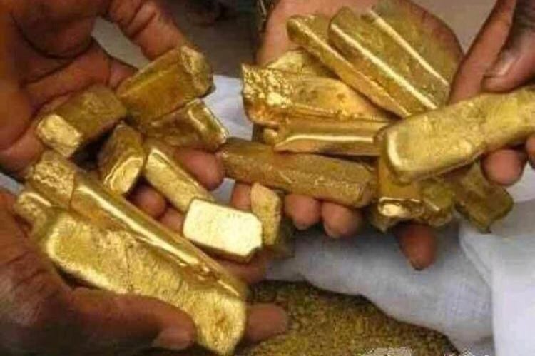 Hands holding a haul of rough cast gold bars