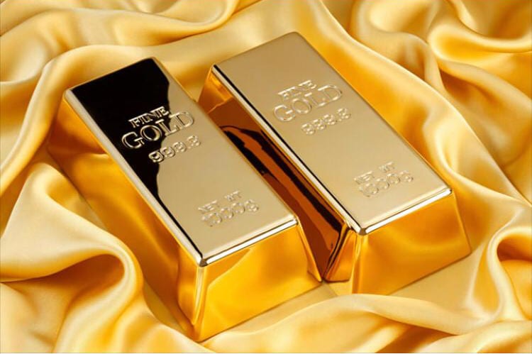 Two Fine Gold 999.9 bullion bars resting on gold satin fabric
